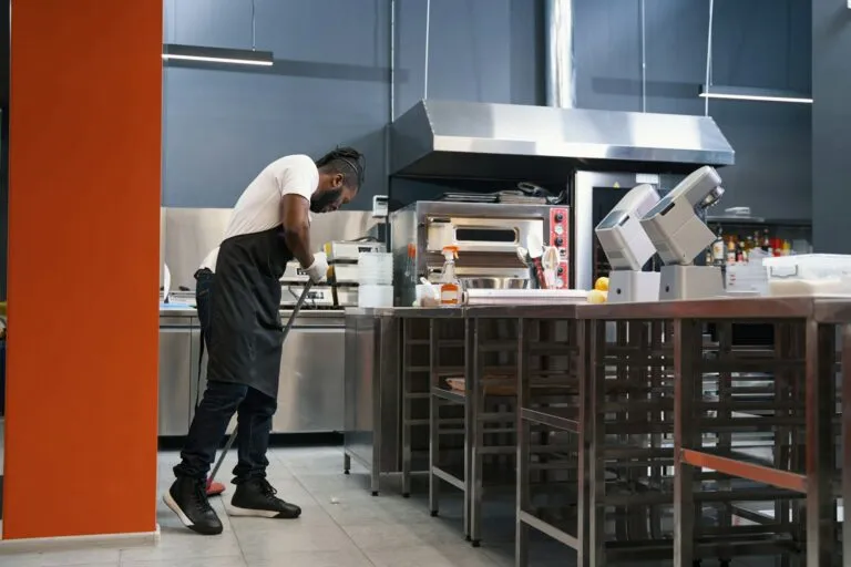 adult chef cleaning work place in restaurant | Dan's HVAC