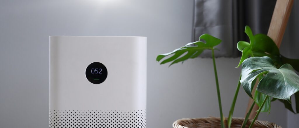 Air purifier with digital monitor screen in bedroom for show air quality and air pollution levels. | Dan's HVAC