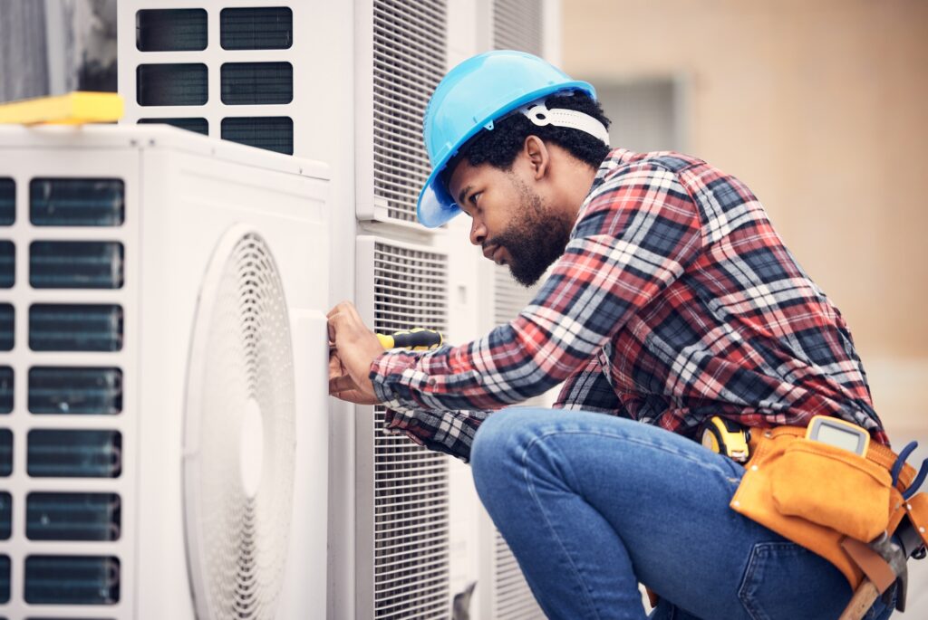 Black man, electrician and maintenance on air conditioner | Dan's HVAC