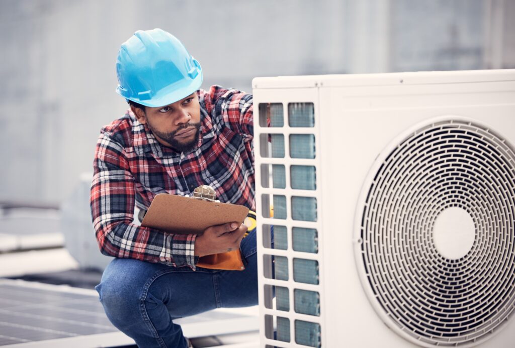 Black man, electrician with clipboard for air conditioner inspection, handyman working on rooftop w