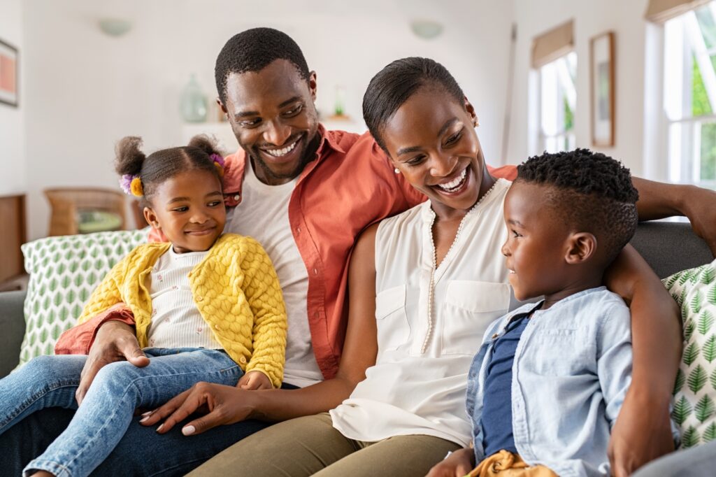 Happy black family playing together at home | Dan's HVAC