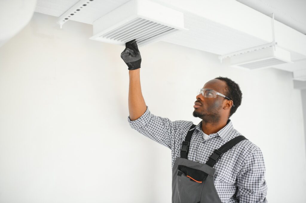 Industrial Theme. Warehouse Heating and Cooling System Installation by Professional Technician. | Dan's HVAC